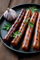 Close-up of a frying pan with grilled sausages, selective focus
