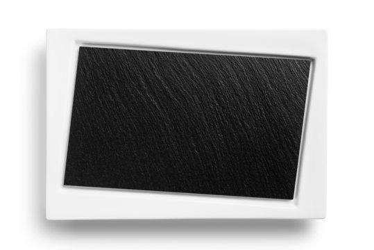 Empty white plate with black stone surface isolated on white bac