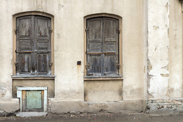 Fototapeta na wymiar Two windows of the old house in Vilnius, shuttered