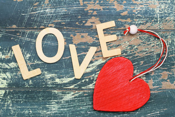 Word love written with wooden letters and red heart