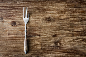Dining fork on vintage wooden table