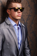 Fashion portrait of man in jacket and sunglasses