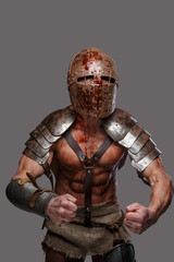 Gladiator with muscular body covered in blood
