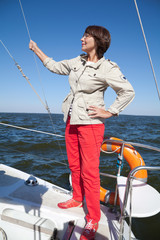 Elderly woman yachtsman on a sailing yacht