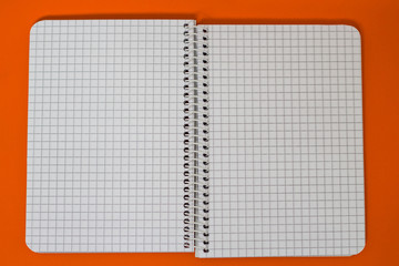 Spiral Notebook at orange Background.