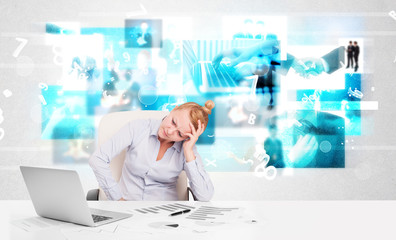 Business person at desk with modern tech images at background