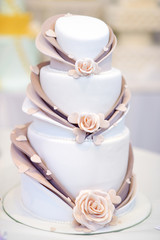 White wedding cake decorated with sugar flowers