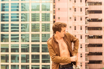 Young man picking something of his Jacket © harodominguez