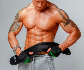 Naklejka premium Strong muscular man poses showing his body.