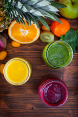 Blended green,yellow and purple smoothie with ingredients select