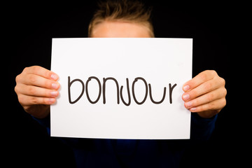 Child holding sign with French word Bonjour - Hello © Mikkel Bigandt