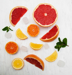 Fresh citrus fruits with ice and green mint