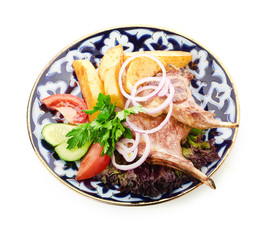 Meat on a grill with vegetables