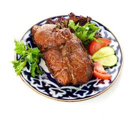 Meat on a grill with vegetables