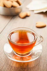 Glass cup of tea on a wooden table.