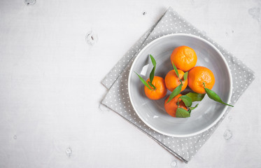 Tangerines on white wooden background. Free space for text