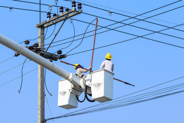 electrician working on electric pole