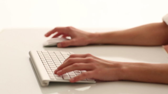 Woman's hands typing on a computer keyboard