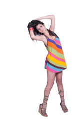 Fashion lady posing in studio wearing colorful mini dress