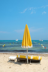Fototapeta na wymiar Beach with parasols and beds