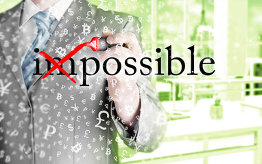 Businessman Hand turning the word Impossible into Possible with
