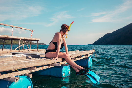 Woman in snorkeling gear on raft