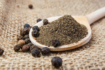 black pepper on the wooden spoon