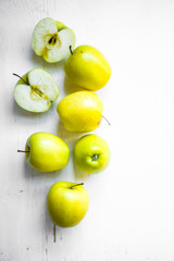 Bright apples on white wooden background