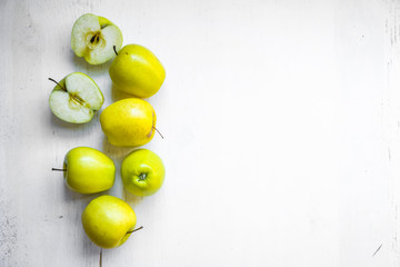 Bright apples on white wooden background