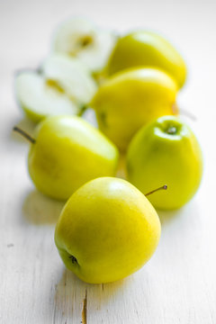 Bright apples on white wooden background