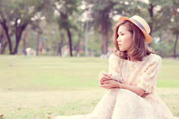 Vintage Girl sit in park listen music via small talk