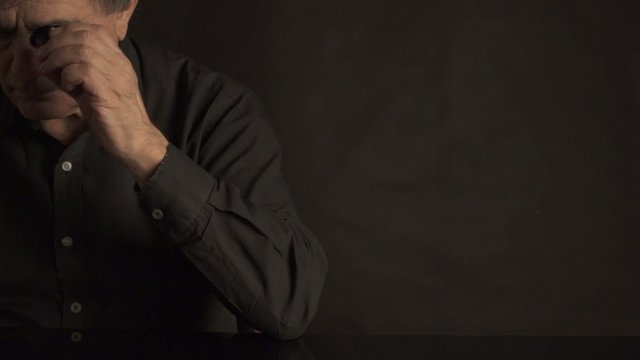 Adult male reviews and appraises the gems and crystals