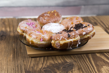 Jummy donuts on wooden table