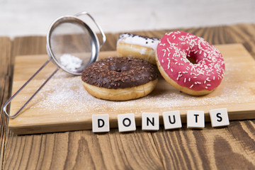 Jummy donuts on wooden table
