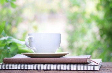 Notebook  and coffee on wooden table