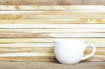 white coffee cup and wood wall