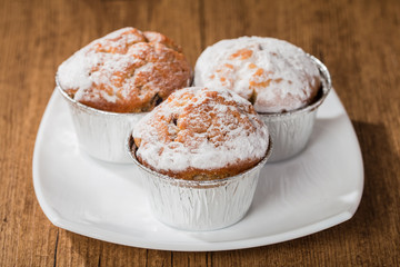 homemade muffins over wooden board selective focus