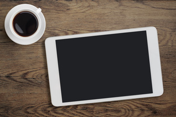 Tablet pc on table desk with coffee cup