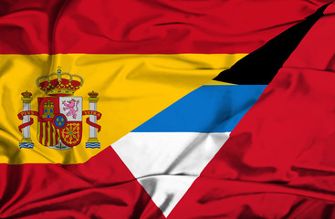 Waving flag of Antigua and Barbuda and Spain