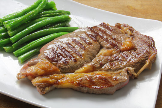 large beef steak with green beans