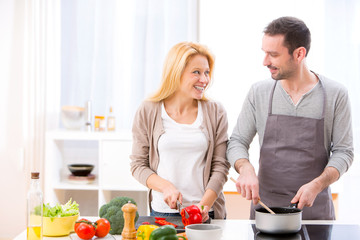 Young attractive couple cooking in a kitchen