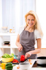 Young attractive woman cooking in a kitchen