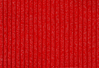 Knit woolen texture. Red and silver woven thread as a background