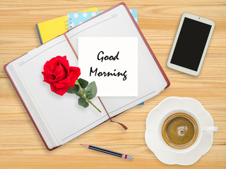 Good morning on paper with red rose and coffee cup