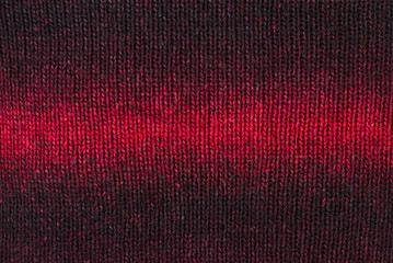 Knit woolen texture.Ombre red woven thread sweater as background