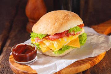 Egg Burger with Ketchup Above Wooden Serving Board