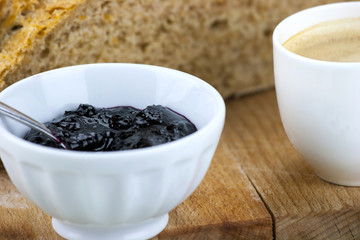 Homemade blueberry jam with integral bread and coffe