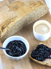 Homemade blueberry jam with integral bread and coffe