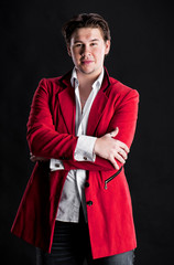 Elegant smiling young handsome man in red suit