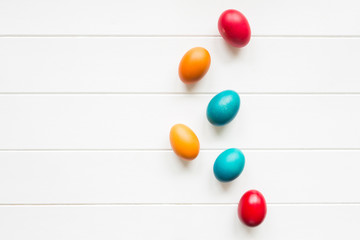 Naklejka na ściany i meble Easter eggs arrangement with copy space on wodden background